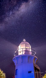 Low angle view of illuminated built structure against blue sky