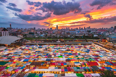 High angle view of buildings in city at sunset