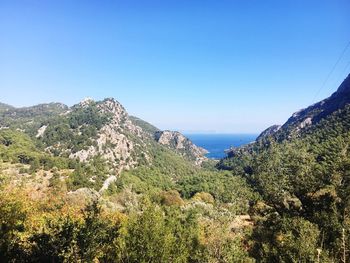 Scenic view of mountains against clear blue sky