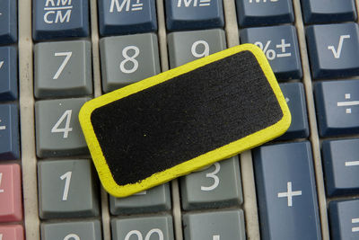 Directly above shot of painted wood on calculator