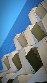 Low angle view of modern building against clear blue sky