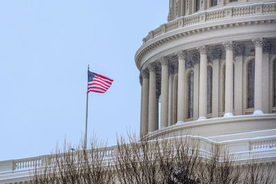 Low angle view of flags against clear sky