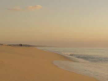 Scenic view of beach against sky during sunset