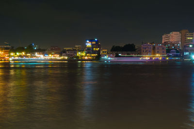 Illuminated city at waterfront