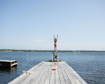 A girl diving from a jetty