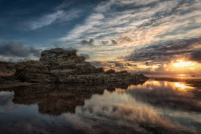 Scenic view of lake against sky at sunset