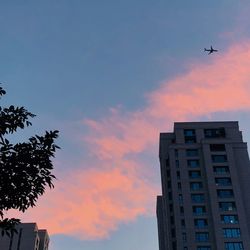 Low angle view of silhouette building against sky during sunset