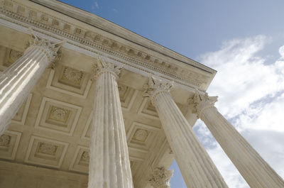 Low angle view of historical building against sky, square house in nîmes, france