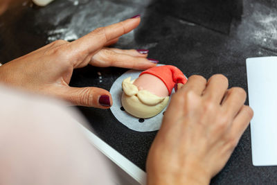 Preparation of a steamed sandwich in the shape of santa claus.