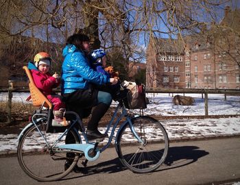 Man riding bicycle on snow during winter