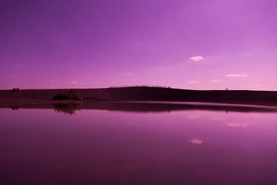 Scenic view of lake against sky at night