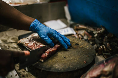 Cropped hand of man preparing food