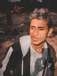 Portrait of young man standing outdoors