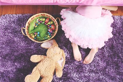High angle view of girl with toys on rug at home
