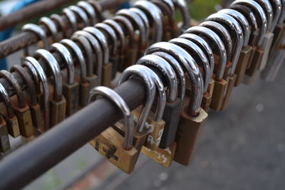 Close-up of padlocks hanging on rusty metal