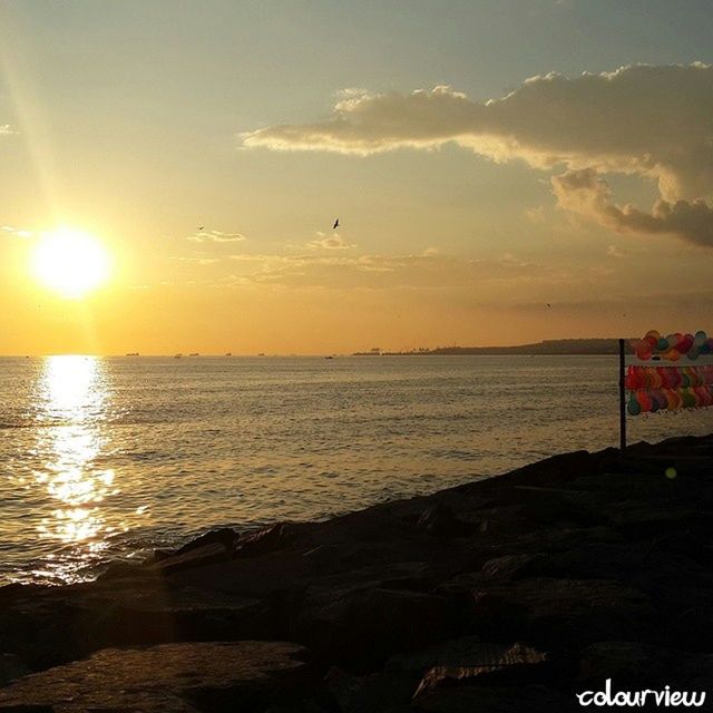 sunset, sea, water, sun, horizon over water, sky, scenics, tranquil scene, beauty in nature, tranquility, sunlight, nature, orange color, idyllic, beach, shore, reflection, sunbeam, outdoors, silhouette