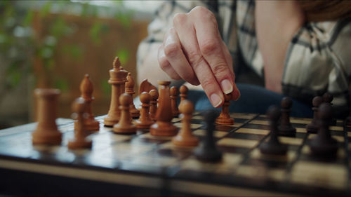 Midsection of woman playing chess