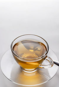 Close-up of tea cup on table against white background