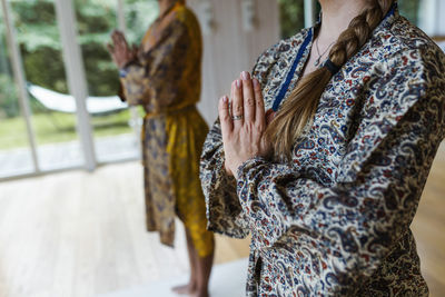 Mid section of woman meditating