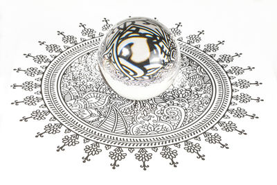 High angle view of crystal ball against white background