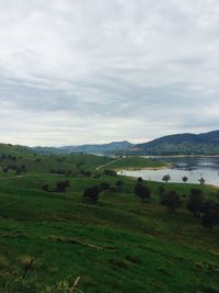 Scenic view of landscape against cloudy sky