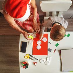 High angle view of couple holding hands on table