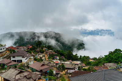 Houses in city against sky