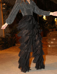 Low section of woman standing on rock at night