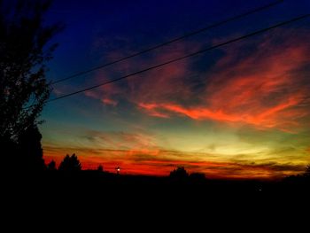 Silhouette trees against sky during sunset