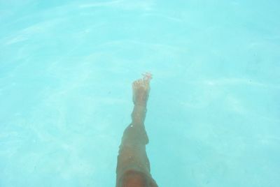 Low angle view of woman standing against blue sky