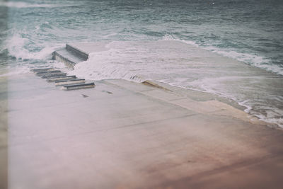 High angle view of waves reaching shore at beach