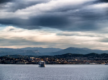 Sea by cityscape against sky