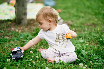 Cute boy playing with toy on field