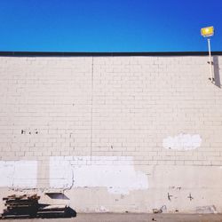 Low angle view of street light against clear blue sky