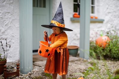 Girl wearing halloween costume while standing outdoors