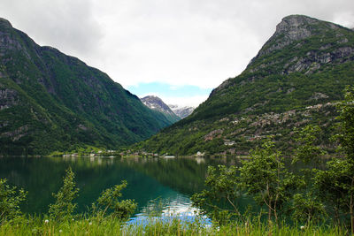 Scenic view of lake and mountains against sky