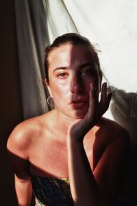 Portrait of young woman sitting at home