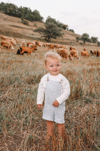 Portrait of boy standing in a field