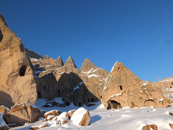 Scenic view of snowcapped mountains against clear blue sky