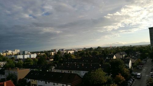 High angle shot of cityscape against cloudy sky