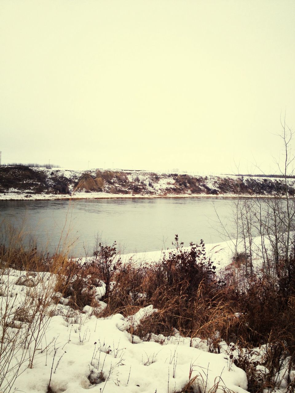 clear sky, winter, snow, cold temperature, water, copy space, tranquil scene, tranquility, lake, season, scenics, nature, beauty in nature, river, frozen, weather, landscape, tree, plant, day