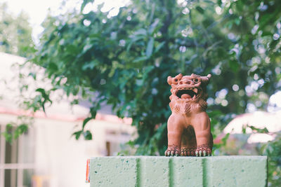 Dog statue against trees