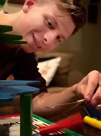 Close-up of teenage boy playing game on table