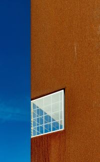 Close-up of building against blue sky