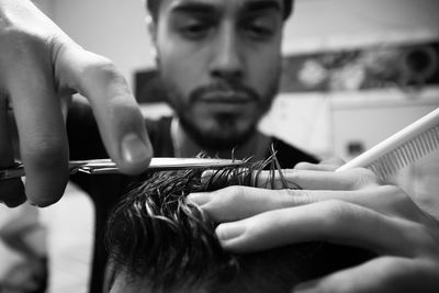 Barber cutting hair of man in the barber shop