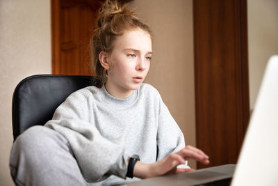 Young woman using laptop at home