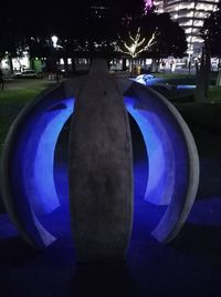 Close-up of illuminated lighting equipment on street at night