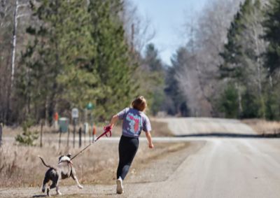 Full length of woman with dog