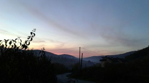 Scenic view of silhouette mountains against sky at sunset