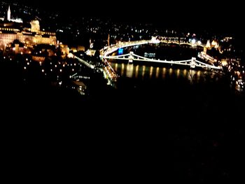 Illuminated bridge in city at night